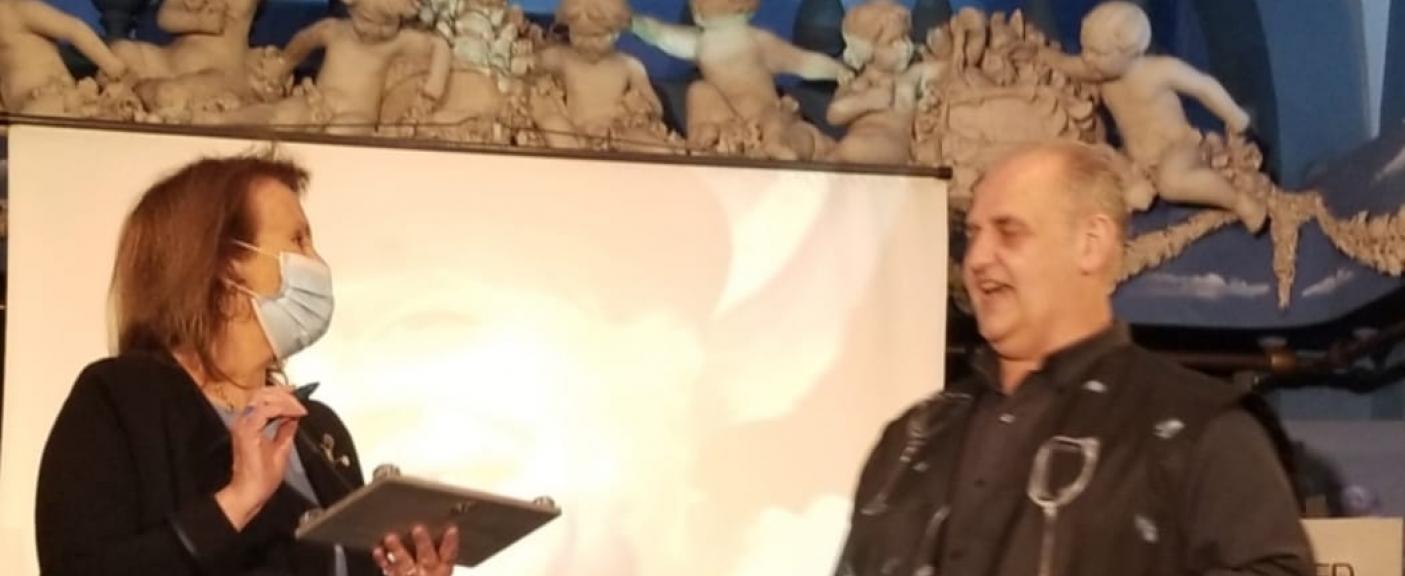 Stefania Vecchi recibiendo la placa en reconocimiento a su trayectoria